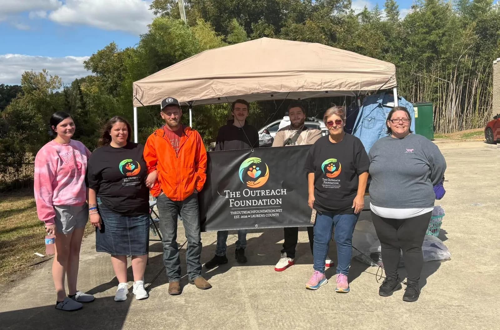The Outreach Foundation team under the canopy tent at the 2026 coat drive