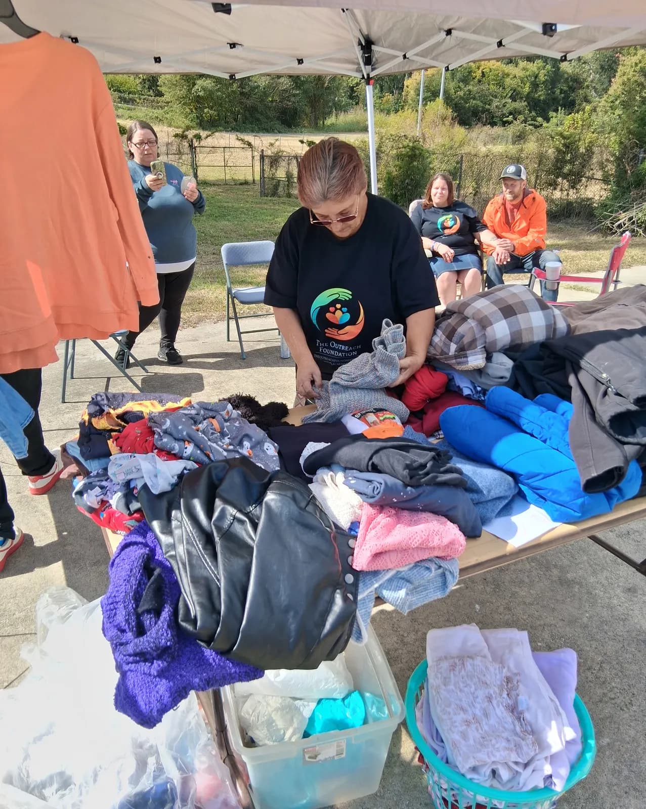 Our president, Joyce Stephens, sorting clothes at the giveaway table